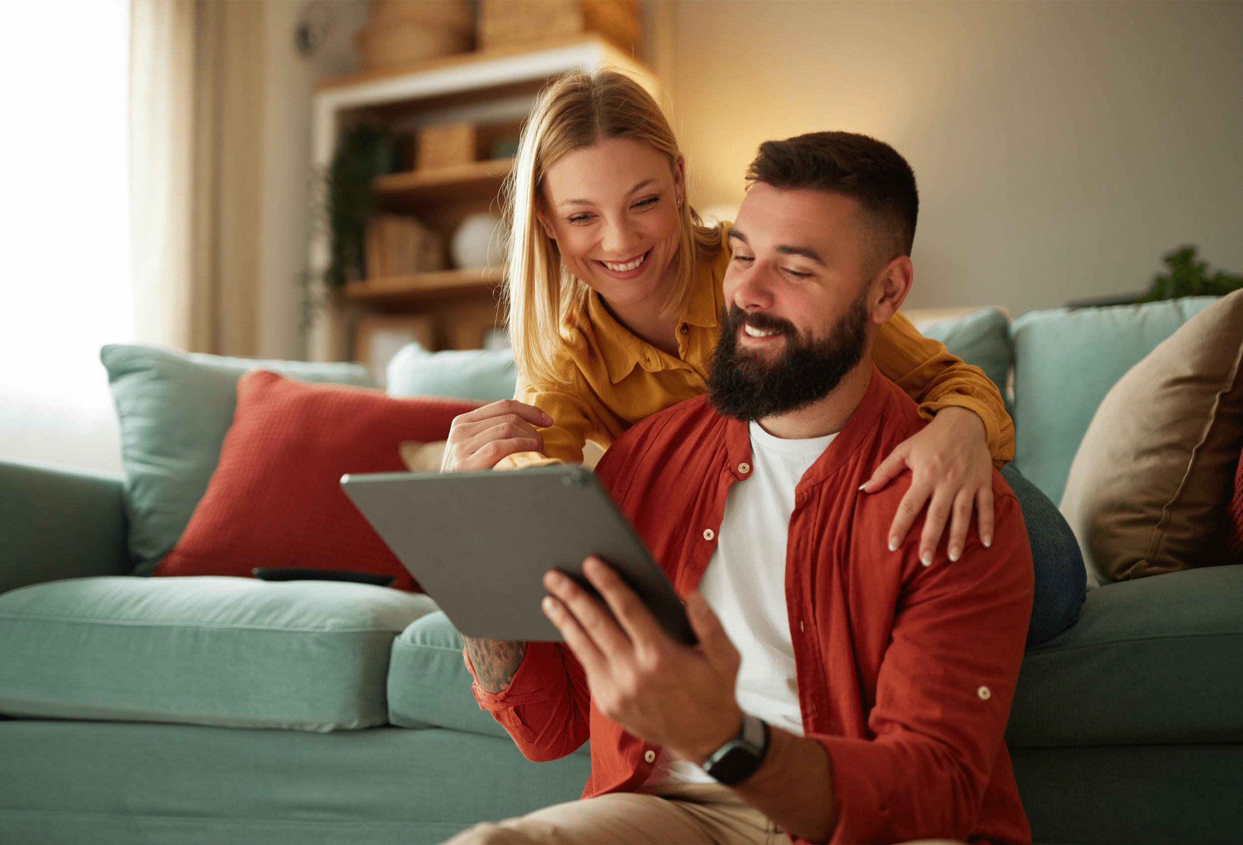 Couple looking at tablet smiling